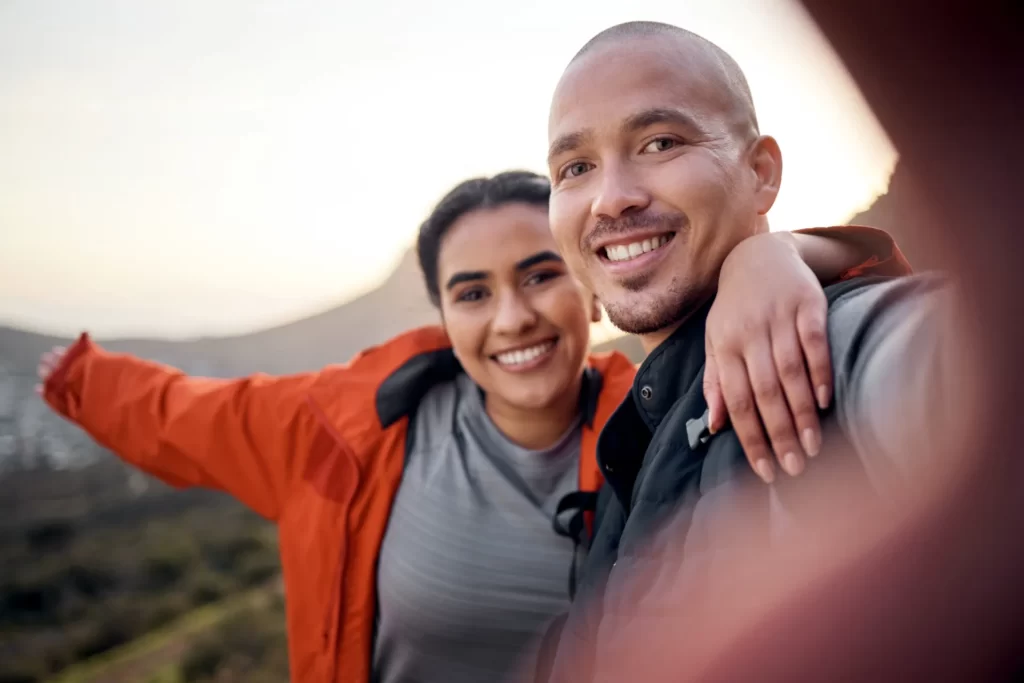 happy couple enjoying scenic hike adventure togeth utc